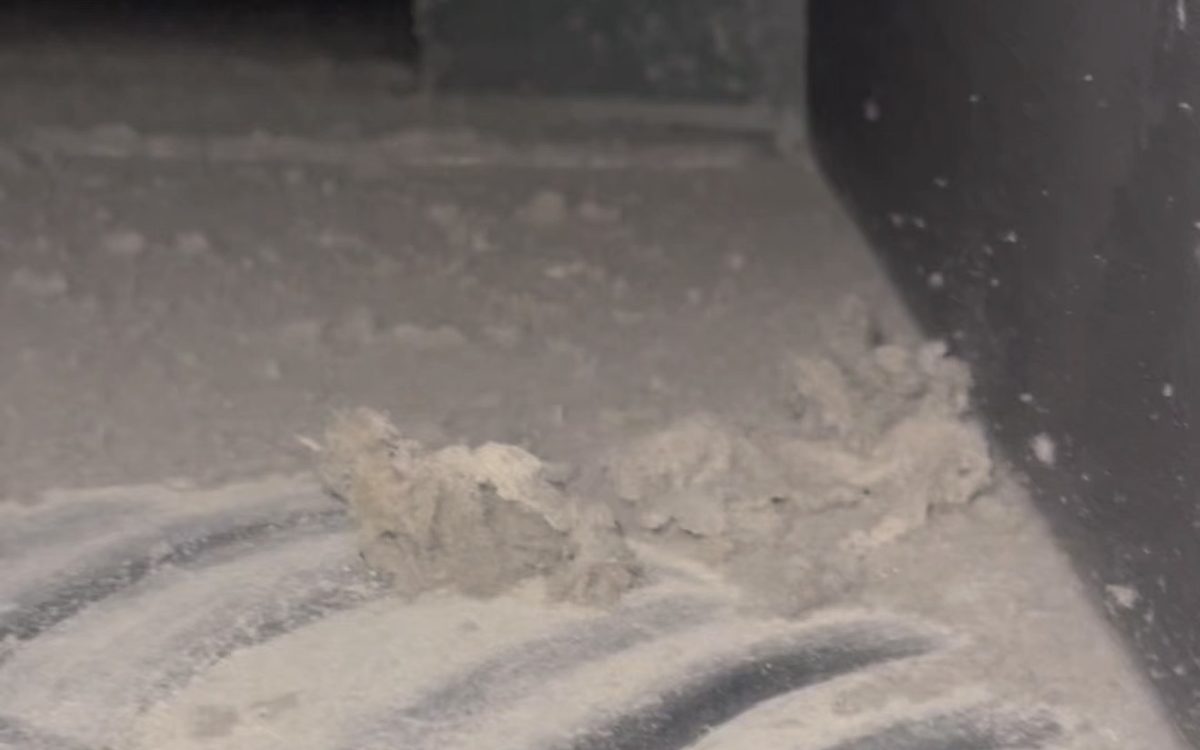 Inside a real Dubai air duct: a thick layer of dust with finger marks