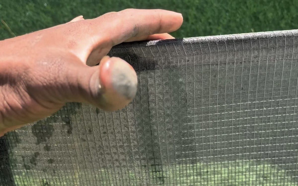 Our technician holding an AC filter, fingertips grey with dust